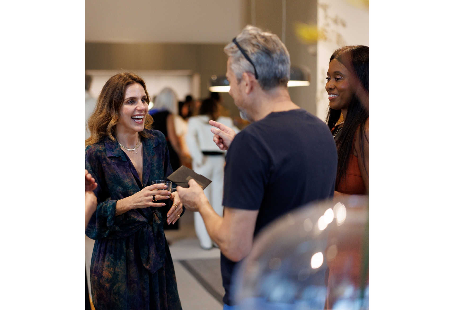 bulthaup Miami showroom and bulthaup b3 kitchens with event guests smiling and laughing.