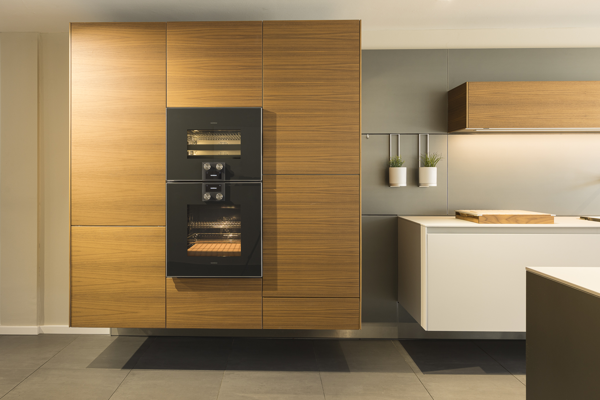 Bulthaup Küchenschrankwand mit integrierten Einbauöfen und Holzverkleidung – moderne Küchenarchitektur Heidelberg - Gaggenau
